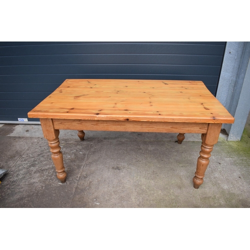 421 - A late 20th century thick pine topped kitchen table. 152 x 89 x 78cm tall. In good functional condit... 