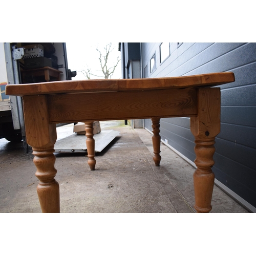 421 - A late 20th century thick pine topped kitchen table. 152 x 89 x 78cm tall. In good functional condit... 