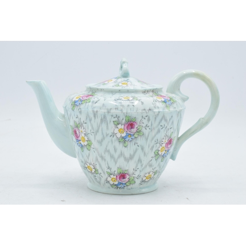 69 - Paragon Fine China teapot with floral decoration on a light blue / duck egg green background. In goo... 