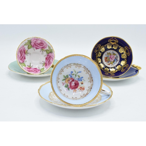 84 - A collection of Aynsley cups and saucers to include a pink rose / cabbage rose example, a similar bl... 