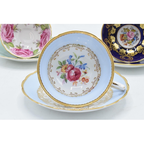 84 - A collection of Aynsley cups and saucers to include a pink rose / cabbage rose example, a similar bl... 