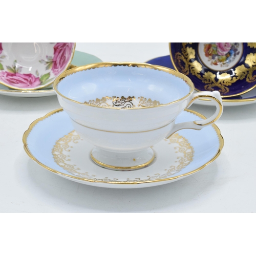 84 - A collection of Aynsley cups and saucers to include a pink rose / cabbage rose example, a similar bl... 