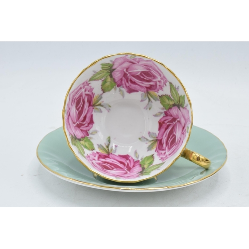 84 - A collection of Aynsley cups and saucers to include a pink rose / cabbage rose example, a similar bl... 