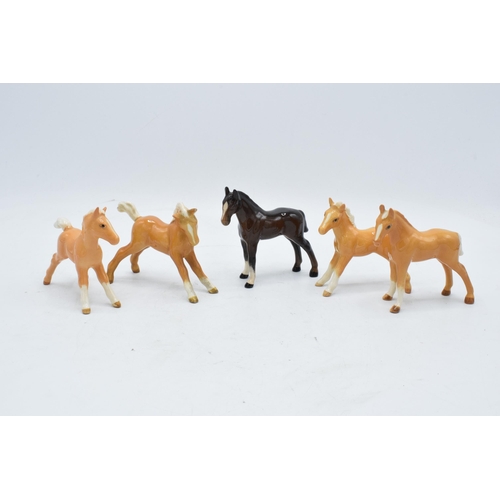 148D - A collection of Beswick foals to include palomino examples and a brown example (5). In good conditio... 