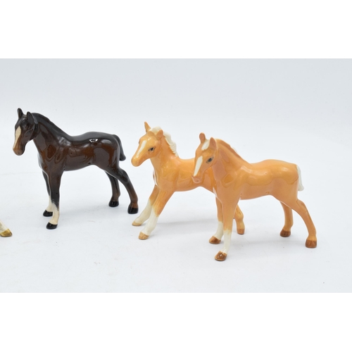 148D - A collection of Beswick foals to include palomino examples and a brown example (5). In good conditio... 