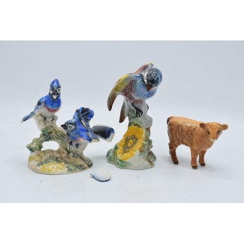 104 - A collection of Beswick animals to include a highland calf, chickadee 929 and American blue jays 925... 