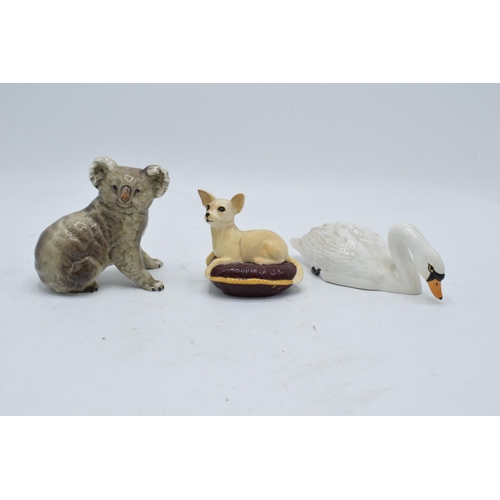 105 - A collection of Beswick to include a koala bear 1038, chihuahua on cushion 2454 and swan with head d... 