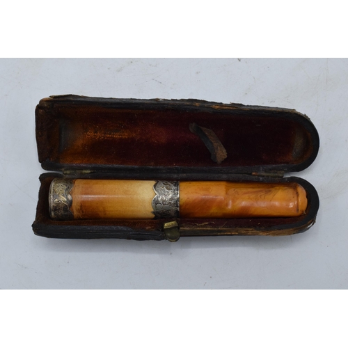 208 - A cased cheroot / cigarette holder with 2 silver collars.