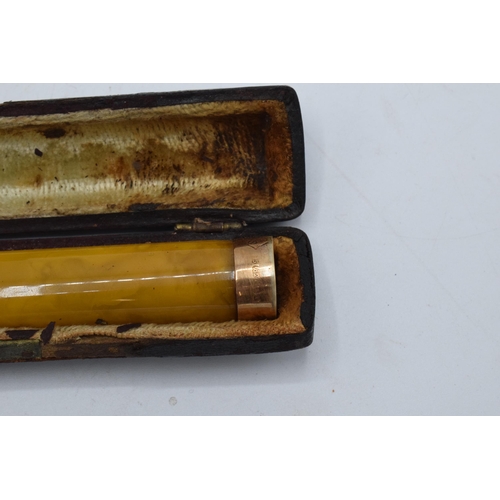 209 - A cased cheroot holder with a 15ct gold mount / collar.