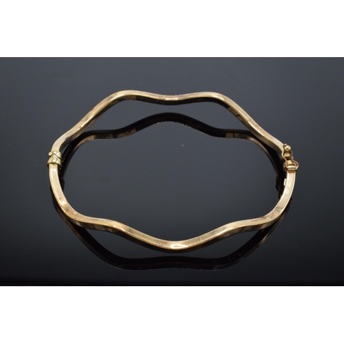 217 - 9ct gold shaped bangle (hollow). 4.1 grams. Hallmarks to inner side. 7cm diameter.