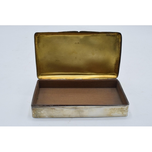 220 - A silver cigarette box with wooden lining. 14 x 8 x 3cm. In clean condition with some scratches and ... 