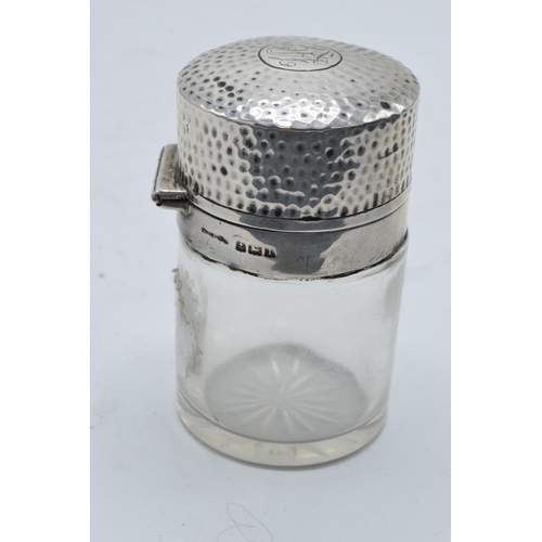 221 - A silver topped glass scene bottle with glass stopper. Birmingham 1910. 8cm tall. In good condition.