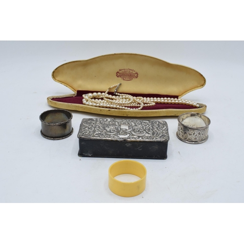 222 - A collection of silver items to include a silver-topped box, a silver napkin ring (14.3 grams), an E... 