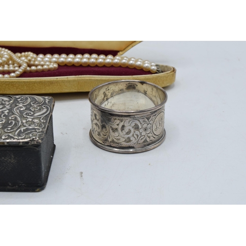 222 - A collection of silver items to include a silver-topped box, a silver napkin ring (14.3 grams), an E... 