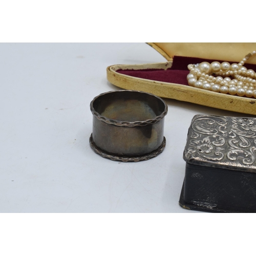 222 - A collection of silver items to include a silver-topped box, a silver napkin ring (14.3 grams), an E... 