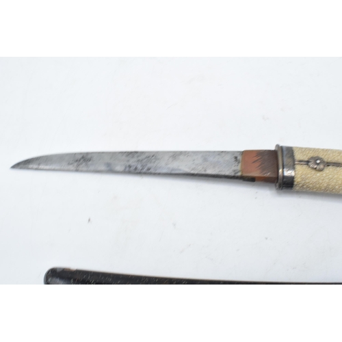 227 - A Japanese Tanto with shagreen handle and metal mounts. 29cm long. Length of blade 17cm.