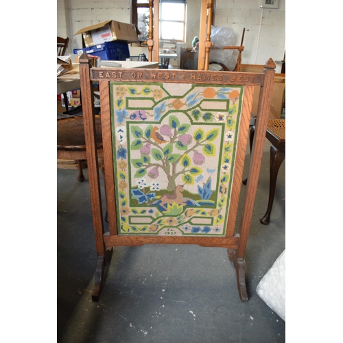 238 - A 1930s wooden and tapestry firescreen 'East or West + Hames Best'. 83cm tall.