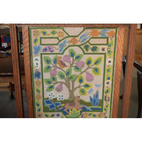 238 - A 1930s wooden and tapestry firescreen 'East or West + Hames Best'. 83cm tall.