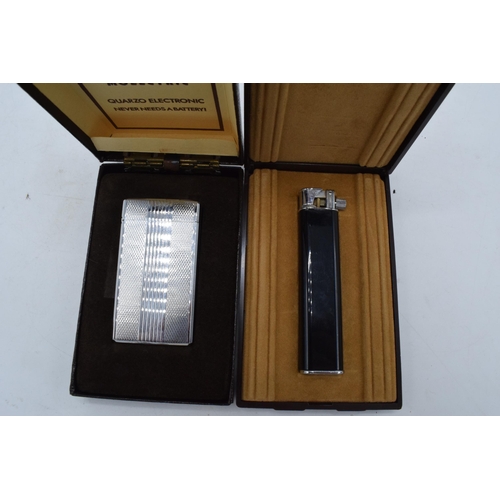 248 - A pair of cased Colibri cigaratte lighters to include a molectric and 1 similar (2).