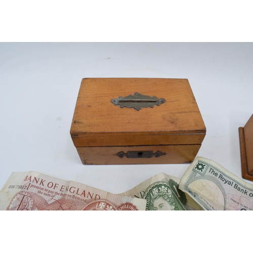 276 - A mixed collection of items to include treen boxes, English currency to include notes such as 10 shi... 