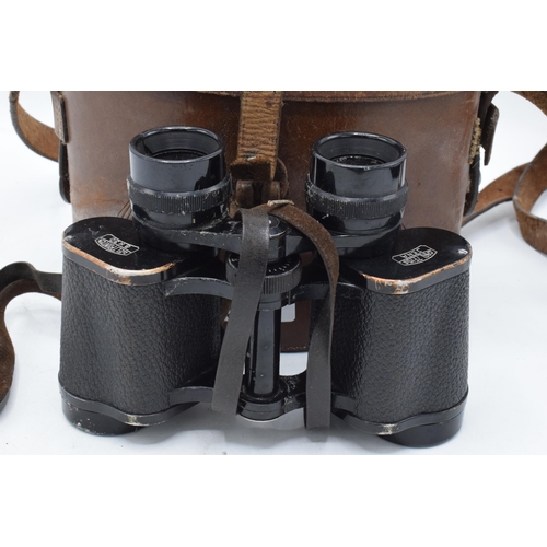 287 - A cased pair of Carl Zeiss Jena Deltrintem 8 x 30 binoculars with leather carry case. With wear and ... 