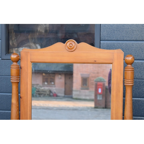 312 - A 20th century pine free-standing full length mirror. 151cm tall.