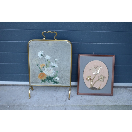 315 - A heavy and painted 20th century brass mirror / fire screen together with an embroidered wall hangin... 