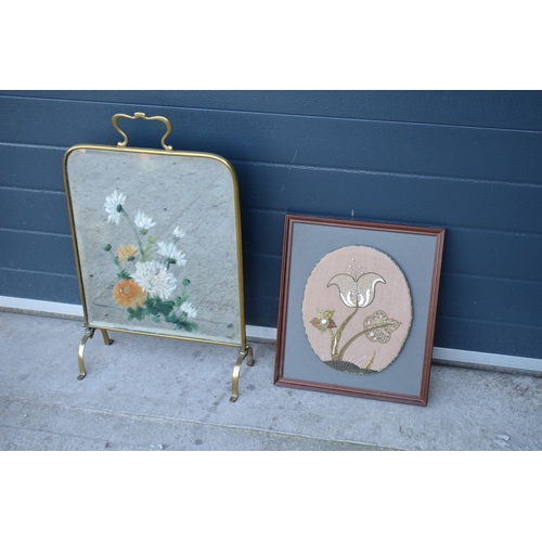 315 - A heavy and painted 20th century brass mirror / fire screen together with an embroidered wall hangin... 