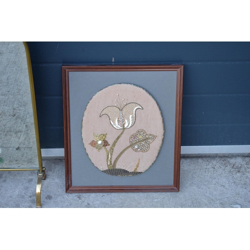 315 - A heavy and painted 20th century brass mirror / fire screen together with an embroidered wall hangin... 