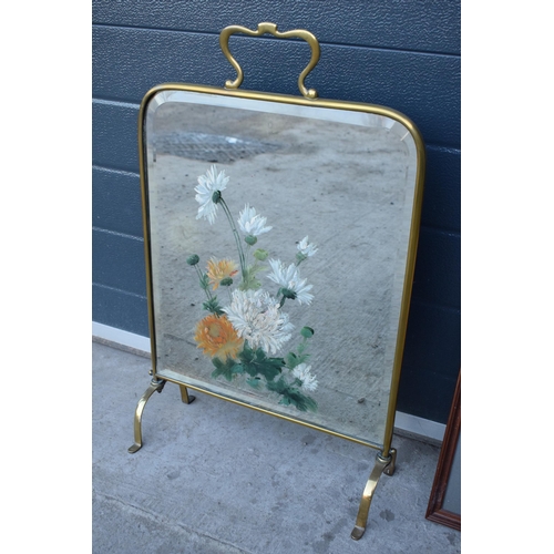 315 - A heavy and painted 20th century brass mirror / fire screen together with an embroidered wall hangin... 