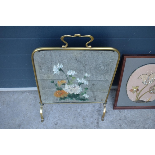 315 - A heavy and painted 20th century brass mirror / fire screen together with an embroidered wall hangin... 