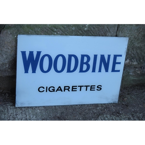 319 - A vintage glass advertising sign of rectangular form for Woodbine Cigarettes. 60 x 40cm. No postage.