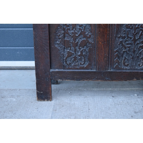 321 - An 18th century thick oak carved chest with fold up lift and iron hinges. 71 x 30 x 61cm tall. Consi... 