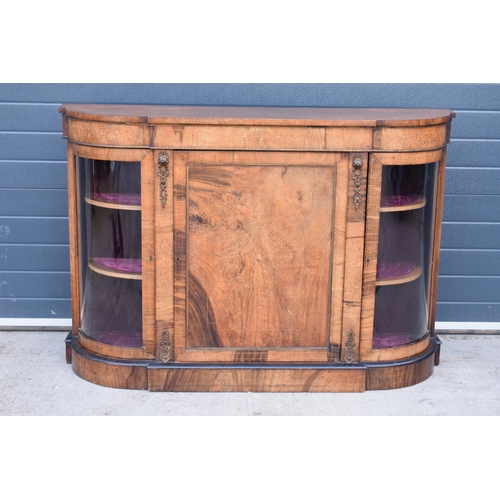 322 - A Victorian walnut breakfront credenza with an inlaid panel door flanked by bow glass doors enclosin... 