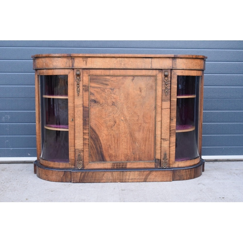 322 - A Victorian walnut breakfront credenza with an inlaid panel door flanked by bow glass doors enclosin... 