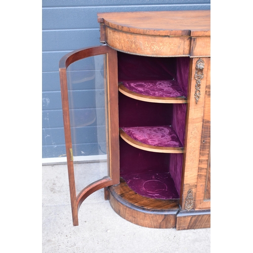 322 - A Victorian walnut breakfront credenza with an inlaid panel door flanked by bow glass doors enclosin... 