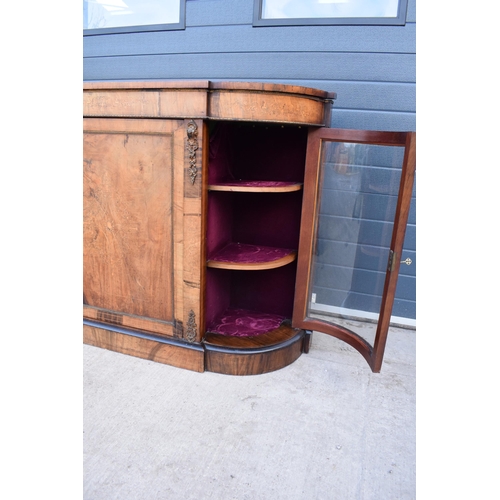 322 - A Victorian walnut breakfront credenza with an inlaid panel door flanked by bow glass doors enclosin... 