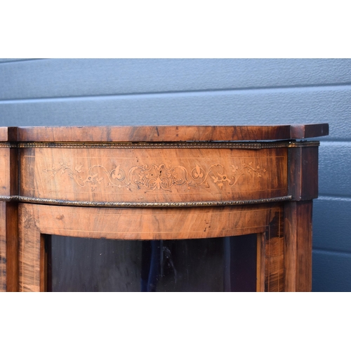 322 - A Victorian walnut breakfront credenza with an inlaid panel door flanked by bow glass doors enclosin... 