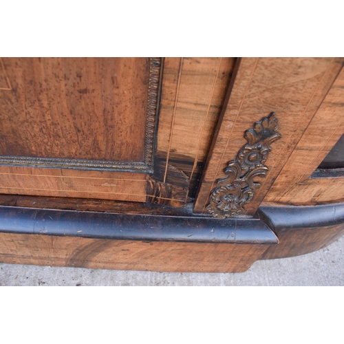 322 - A Victorian walnut breakfront credenza with an inlaid panel door flanked by bow glass doors enclosin... 