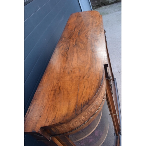 322 - A Victorian walnut breakfront credenza with an inlaid panel door flanked by bow glass doors enclosin... 