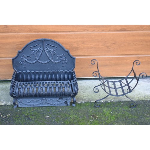 324 - A 20th century fire grill with ornate fireback (54cm wide) together with a shaped wire log basket (2... 