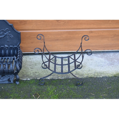 324 - A 20th century fire grill with ornate fireback (54cm wide) together with a shaped wire log basket (2... 