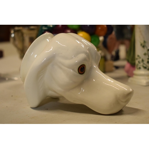 63 - James Kent Old Foley fine bone china stirrup cup in the form of a dog's head in a white glaze. In go... 