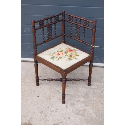 326 - A 19th century Arts and Crafts corner chair with a turned-bobbin back and upholstered seat. 88cm tal... 