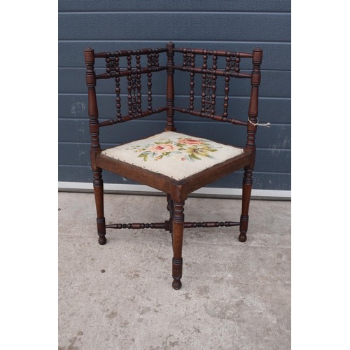 326 - A 19th century Arts and Crafts corner chair with a turned-bobbin back and upholstered seat. 88cm tal... 