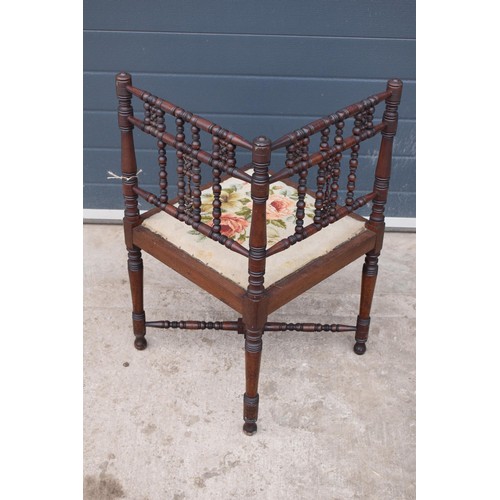 326 - A 19th century Arts and Crafts corner chair with a turned-bobbin back and upholstered seat. 88cm tal... 