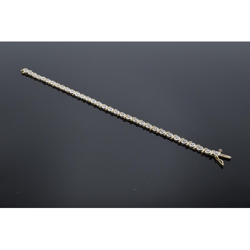 415 - 9ct gold and white gold tennis bracelet with illusion set diamonds. 6.3 grams. 19cm long.