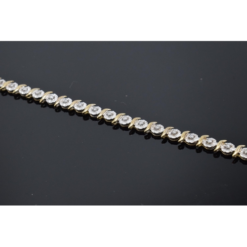 415 - 9ct gold and white gold tennis bracelet with illusion set diamonds. 6.3 grams. 19cm long.