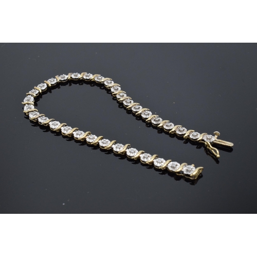 415 - 9ct gold and white gold tennis bracelet with illusion set diamonds. 6.3 grams. 19cm long.