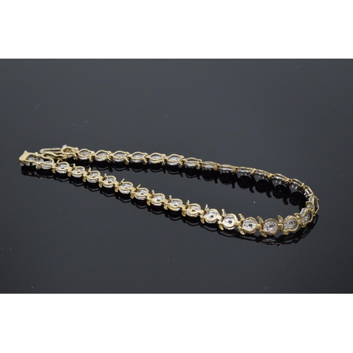 415 - 9ct gold and white gold tennis bracelet with illusion set diamonds. 6.3 grams. 19cm long.